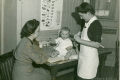Nurse Rickard (Canadian Victorian Order) at infant welfare clinic
