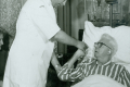 Male nurse assesses patient, 1967 (note the canary)